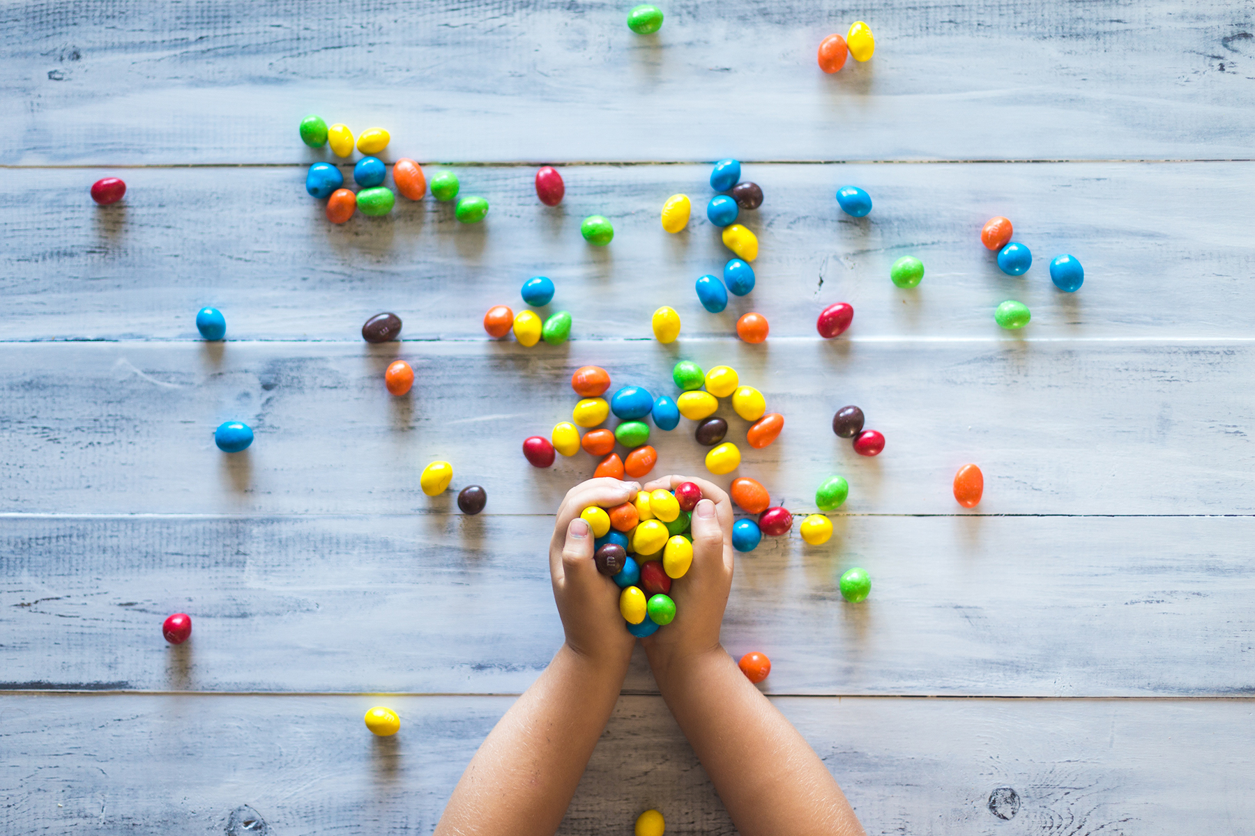 A hand filled with candy