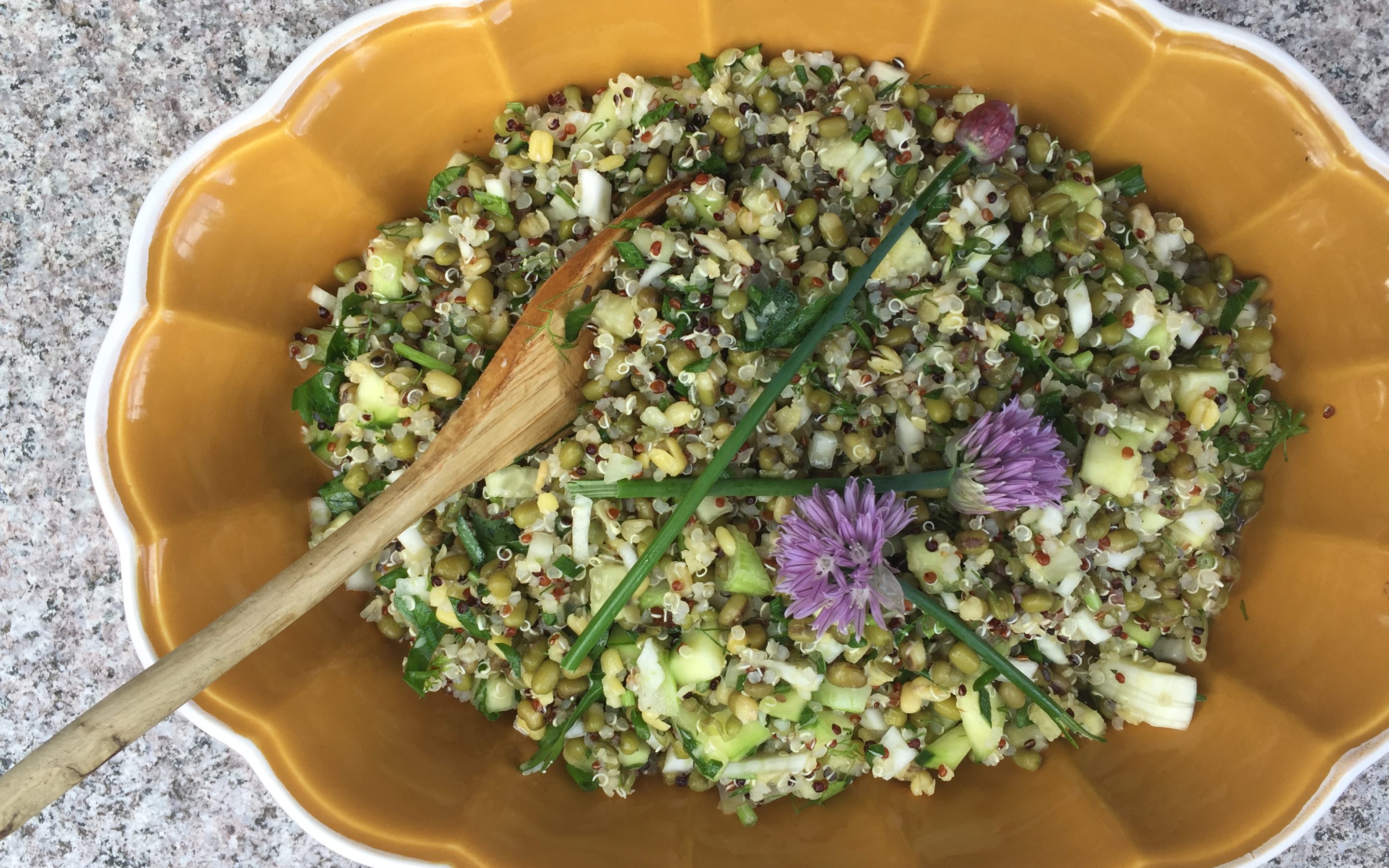 mung bean and quinoa salad in a bowl and topped with purple flowers by hudson valley personal chef