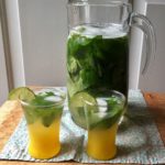 minty lemon-lime refresher in a pitcher with two filled glasses