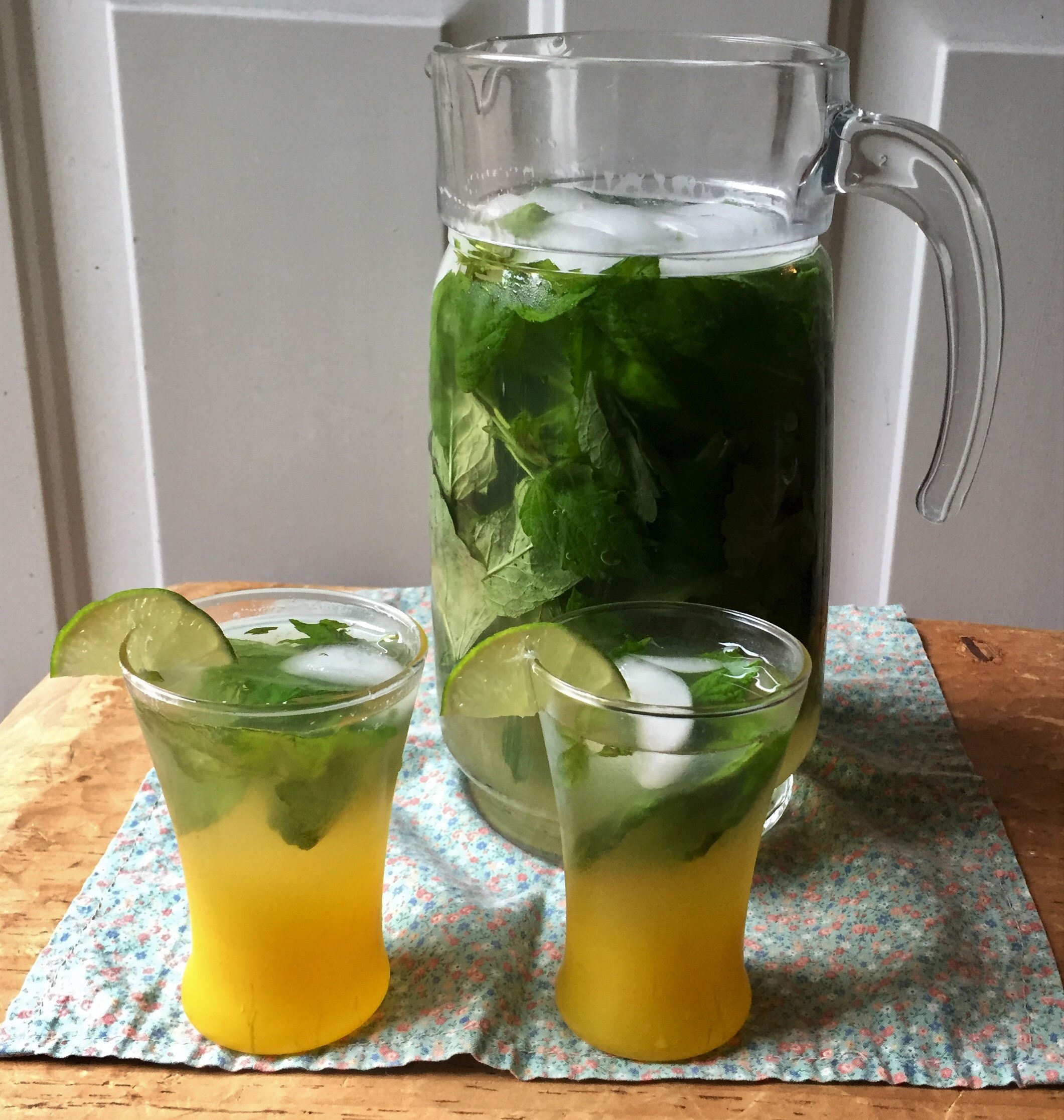 minty lemon-lime refresher in a pitcher with two filled glasses