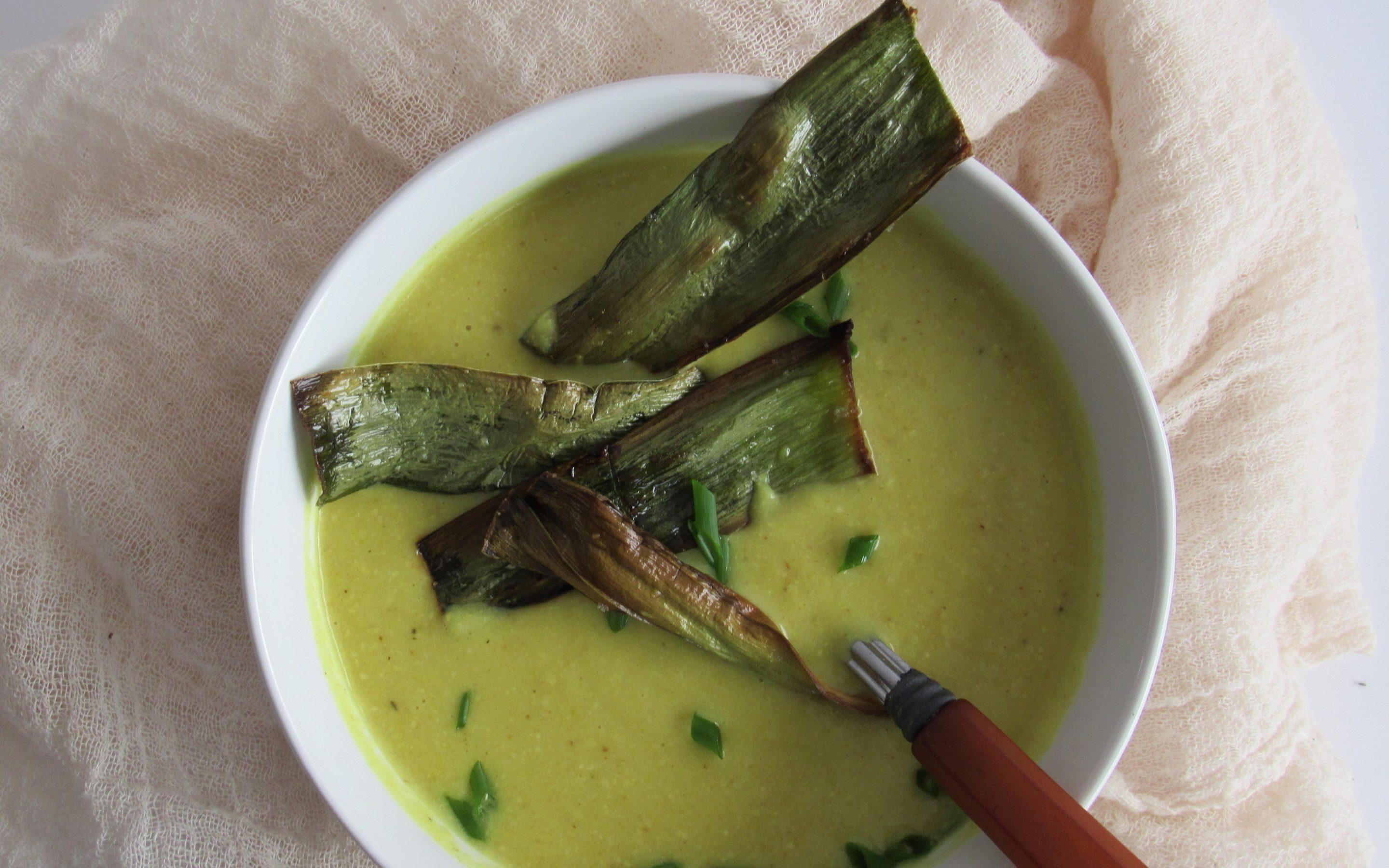 bowl of cauliflower leek soup with leek crisps