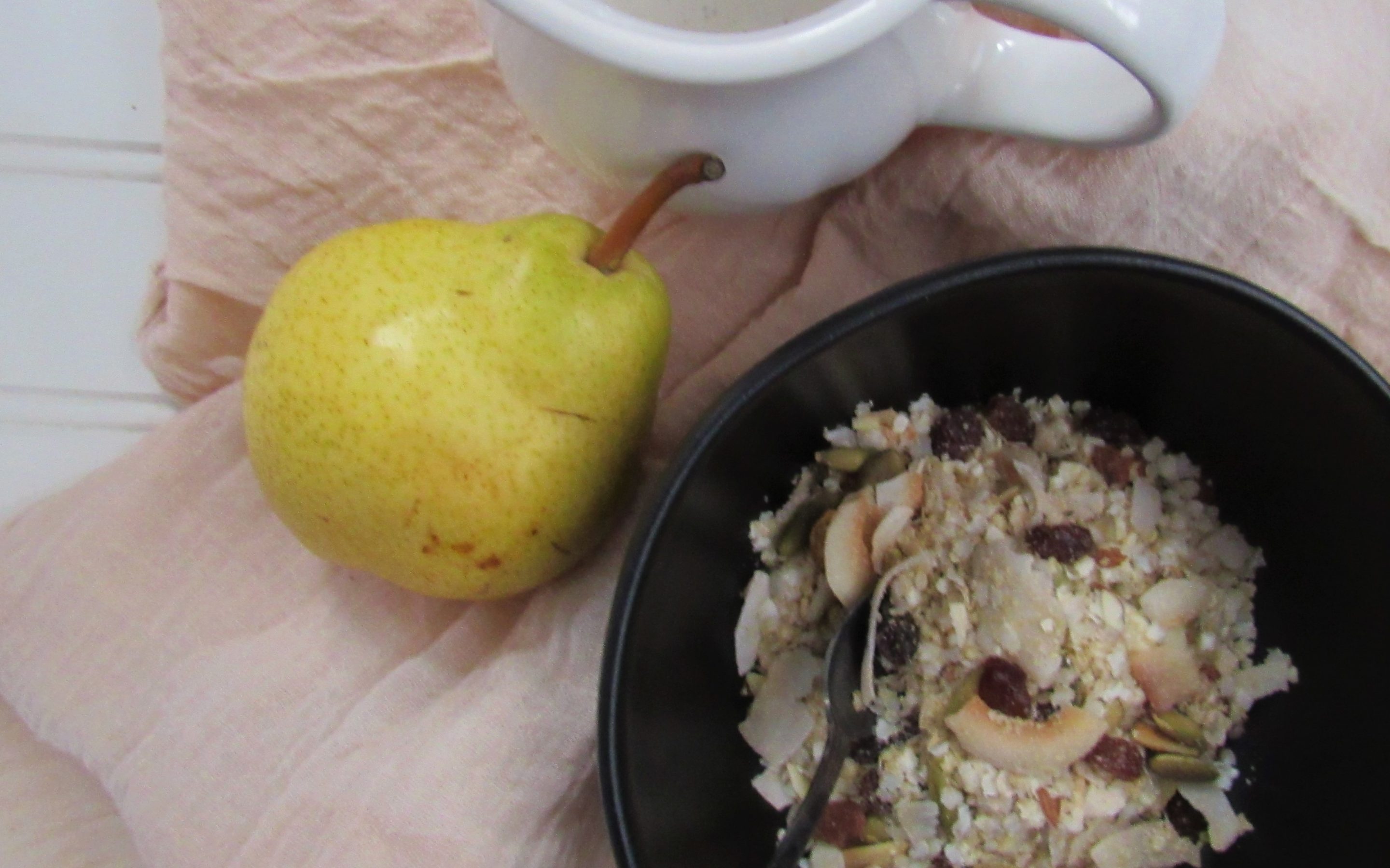 a pear and fruit breakfast bowl on table