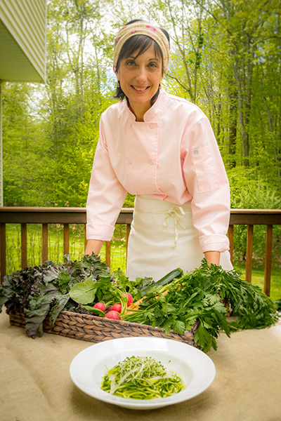 photo of Cathy Vogt outside with fresh vegetables