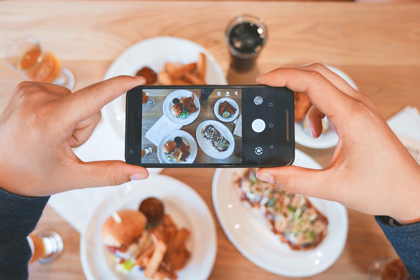 a person taking a photo of food