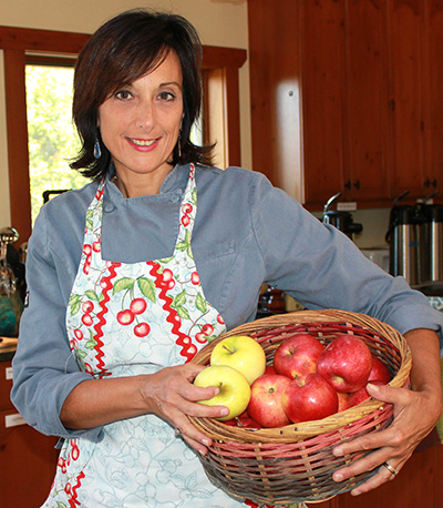 photo of Cathy with a basket of apples