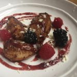 Roasted pears with raspberry sauce on a plate