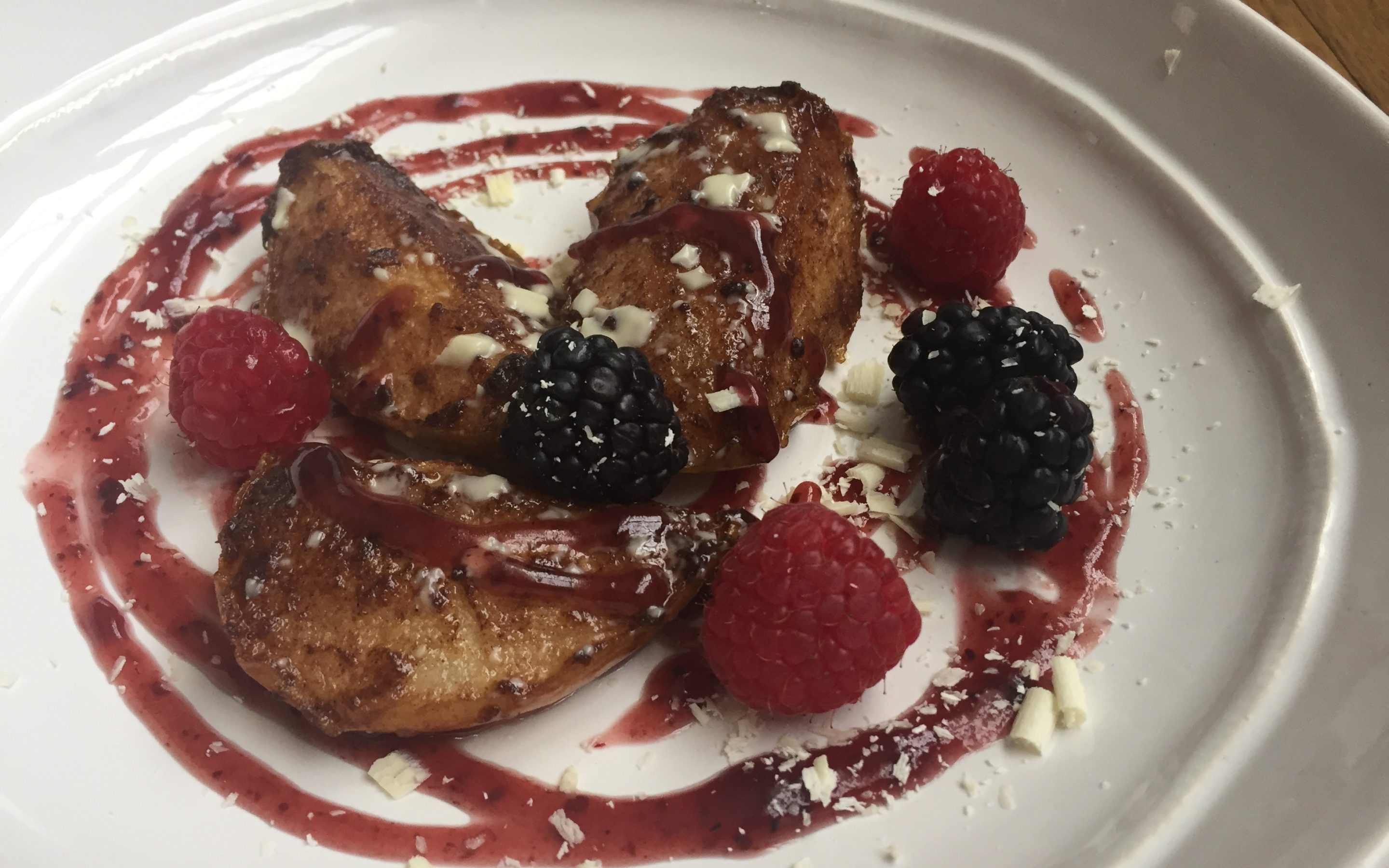 Roasted pears with raspberry sauce on a plate