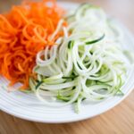 picture of carrot and zucchini noodles on a white plate