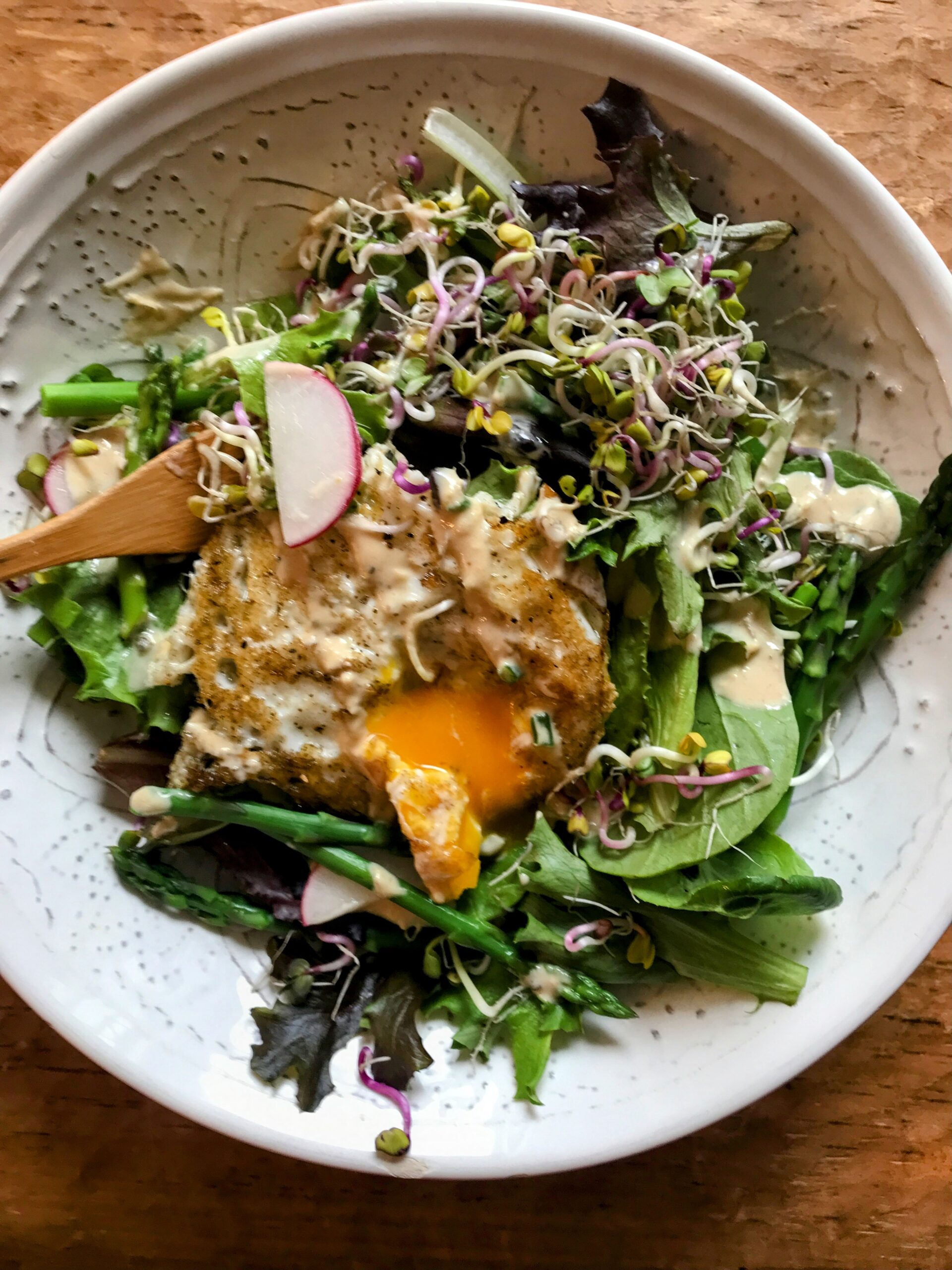 spring time asparagus salad in a white bowl